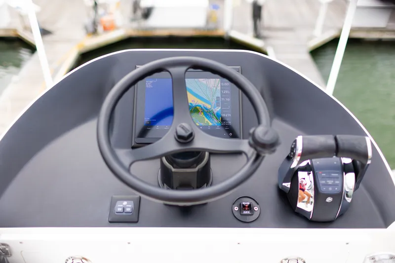 Slide: The Image of Steering console of 2021 Onslow Bay 27 Offshore Edition with navigation display. - 13