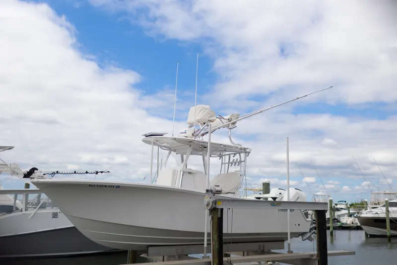 Slide: The Image of 2021 Onslow Bay 27 Offshore Edition boat docked under a cloudy sky. - 36