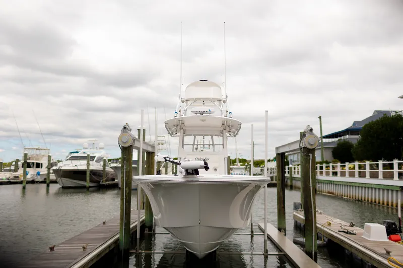 Slide: The Image of 2021 Onslow Bay 27 Offshore Edition boat docked at marina under cloudy sky. - 3