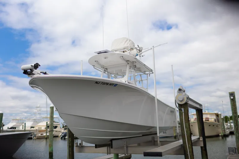 Slide: The Image of 2021 Onslow Bay 27 Offshore Edition boat docked under cloudy sky. - 34