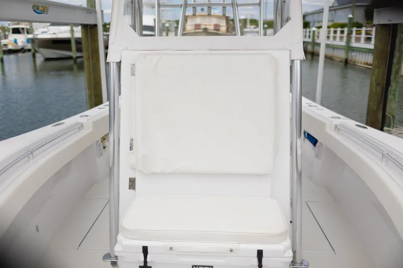 Slide: The Image of 2021 Onslow Bay 27 Offshore Edition boat interior with white seating at marina. - 29