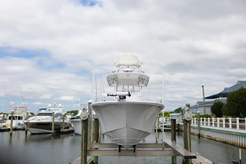 Slide: The Image of 2021 Onslow Bay 27 Offshore Edition boat docked at marina under cloudy sky. - 33