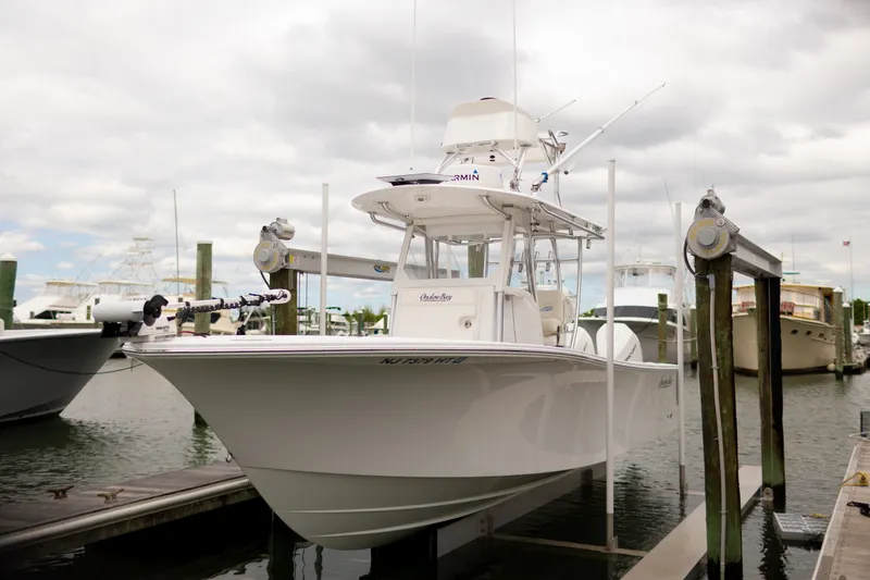 The Image of 2021 Onslow Bay 27 Offshore Edition boat docked at marina under cloudy sky. - 0