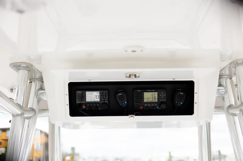 Slide: The Image of 2021 Onslow Bay 27 Offshore Edition boat console with marine radios and controls. - 7