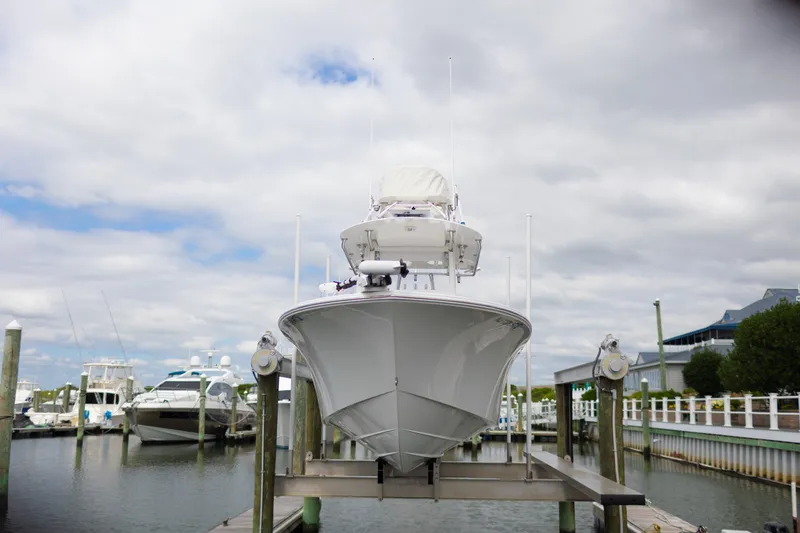 Slide: The Image of 2021 Onslow Bay 27 Offshore Edition boat docked at marina under cloudy sky. - 32