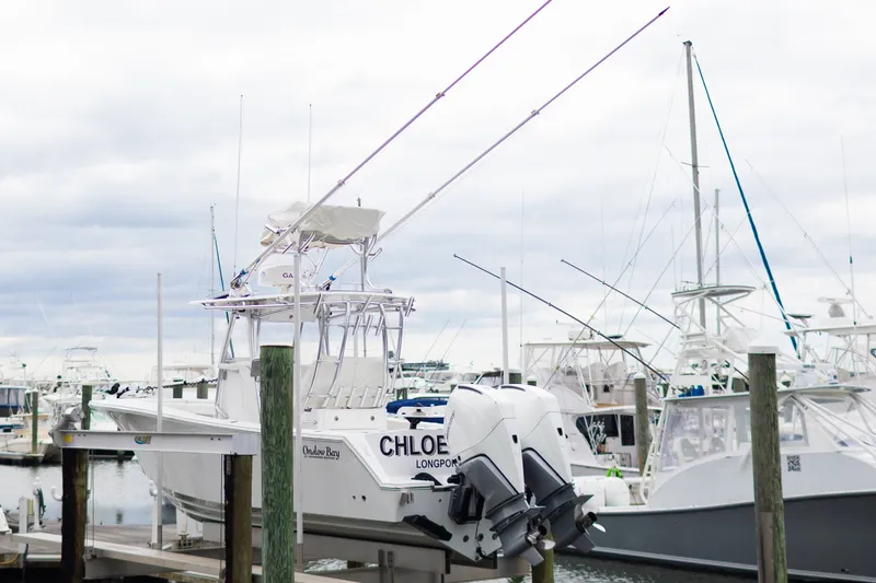 Slide: The Image of 2021 Onslow Bay 27 Offshore Edition boat docked at marina with twin engines. - 37