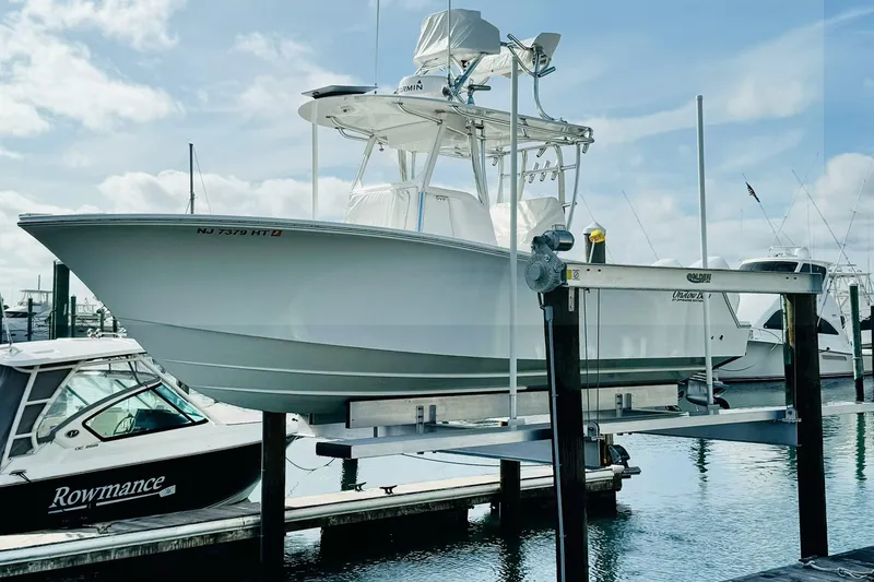 Slide: The Image of 2021 Onslow Bay 27 Offshore Edition boat on lift at marina. - 2
