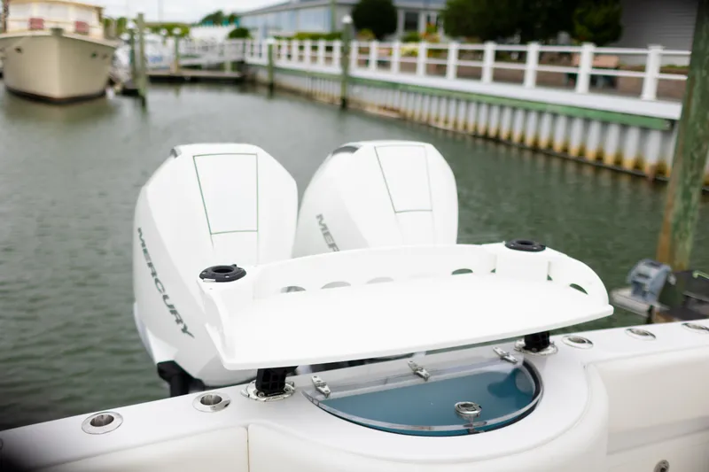 Slide: The Image of 2021 Onslow Bay 27 Offshore Edition boat with dual Mercury engines docked in marina. - 22