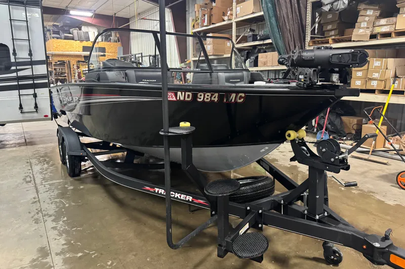 Slide: The Image of 2023 Tracker Targa V-18 WT boat on trailer in warehouse setting. - 2