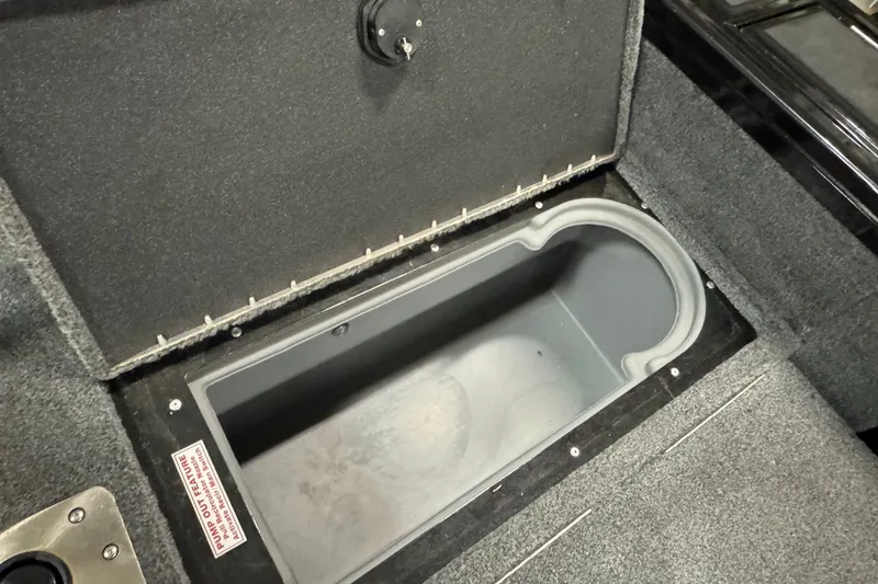 Slide: The Image of 2023 Tracker Targa V-18 WT boat storage compartment, open and empty, with carpeted interior. - 9