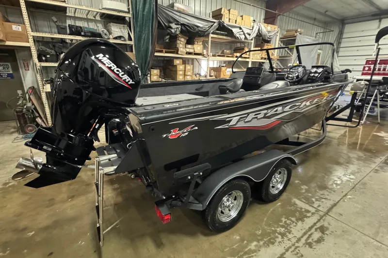 Slide: The Image of 2023 Tracker Targa V-18 WT boat with Mercury engine in a warehouse setting. - 3