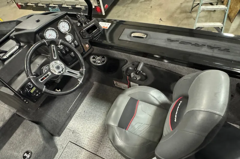 Slide: The Image of 2023 Tracker Targa V-18 WT boat interior with steering wheel and dashboard controls. - 5