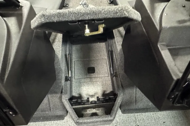 Slide: The Image of 2023 Tracker Targa V-18 WT boat interior storage compartment, open and carpeted. - 18