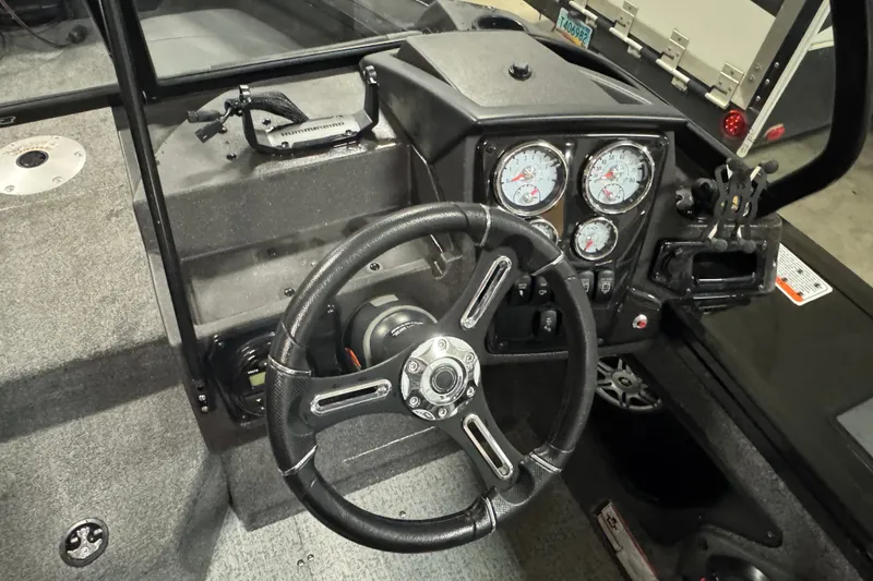 Slide: The Image of 2023 Tracker Targa V-18 WT boat dashboard with steering wheel and gauges. - 6