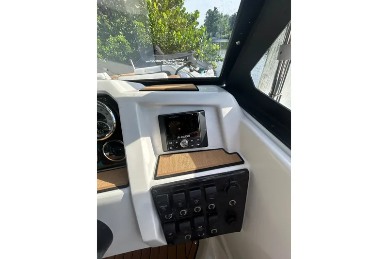 Slide: The Image of 2023 Starcraft SVX 191 OB boat dashboard with JL Audio system and control panel. - 15
