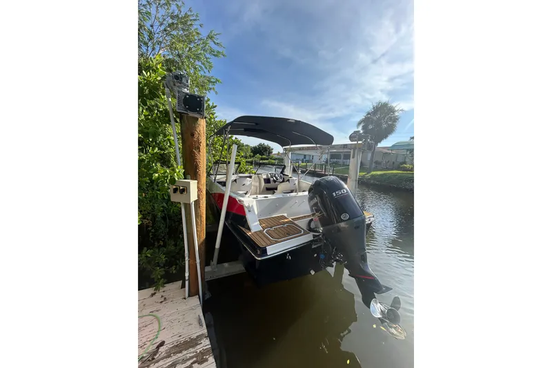 Slide: The Image of 2023 Starcraft SVX 191 OB boat docked, featuring a powerful outboard motor. - 29