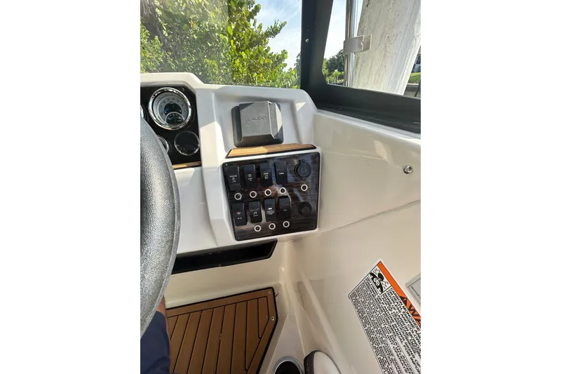 Slide: The Image of 2023 Starcraft SVX 191 OB boat dashboard with control panel and steering wheel. - 16