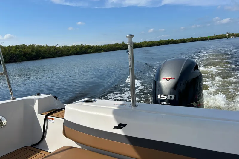 Slide: The Image of 2023 Starcraft SVX 191 OB boat cruising on a calm river with Yamaha 150 engine. - 24