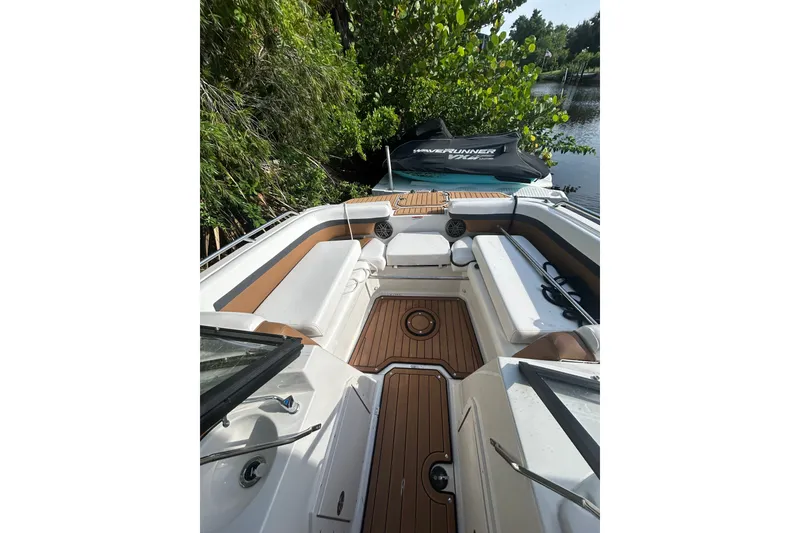Slide: The Image of 2023 Starcraft SVX 191 OB boat interior with cushioned seating and wood accents. - 6