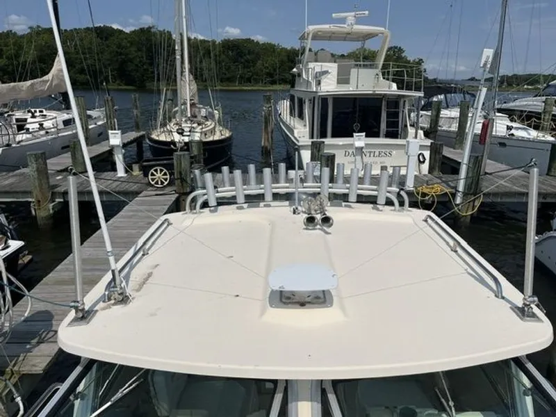 Slide: The Image of A 2011 Parker 2520 XL Sport Cabin boat docked, surrounded by other boats. - 3