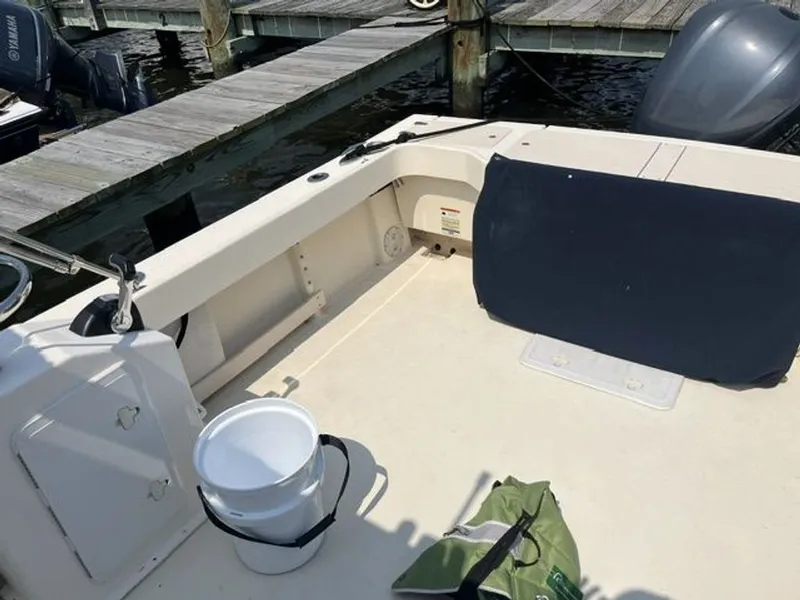 Slide: The Image of The image shows the cockpit of a 2011 Parker 2520 XL Sport Cabin boat docked at a pier. - 10