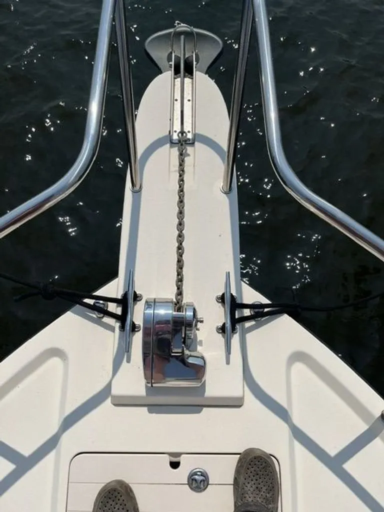 Slide: The Image of The bow view of a 2011 Parker 2520 XL Sport Cabin boat shows an anchor windlass and chain. - 13