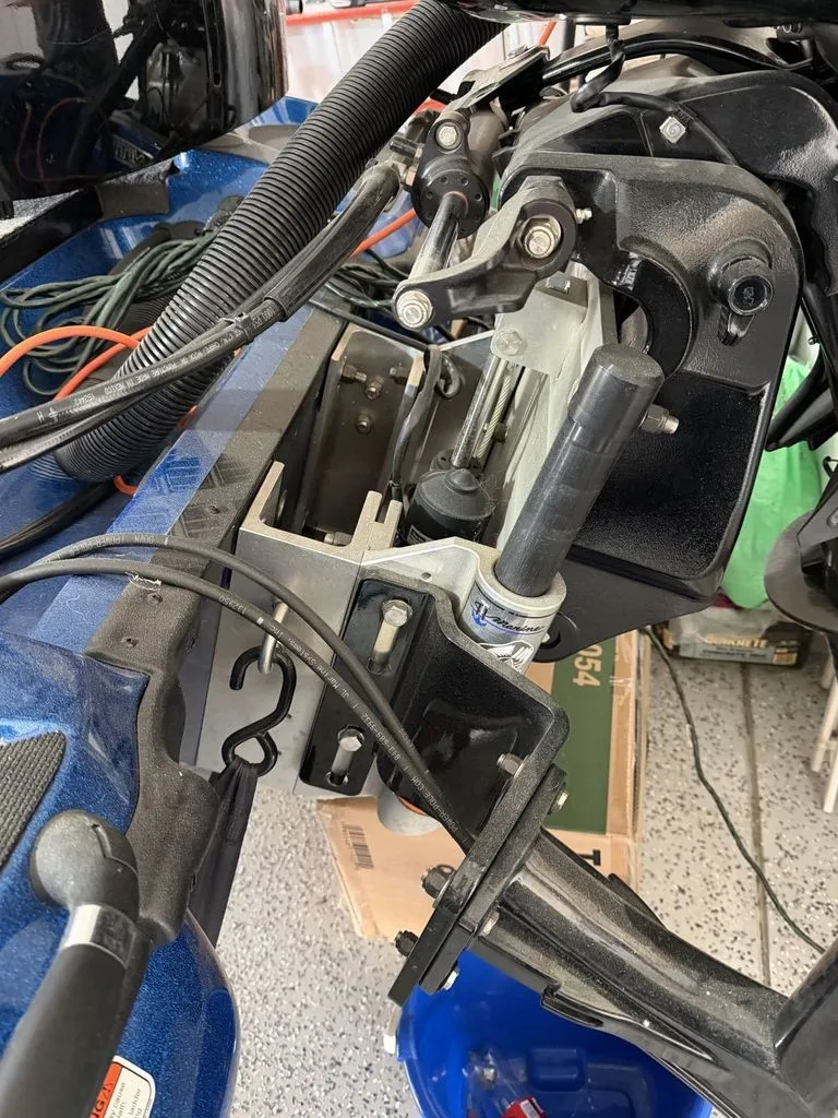 Slide: The Image of Close-up of a boat's stern with motor mount and cables, in a workshop setting. - 30