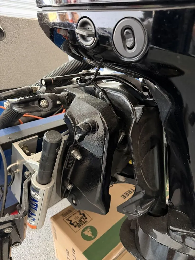 Slide: The Image of Close-up of a boat's outboard motor with cables and hoses, mounted on a trailer. - 23