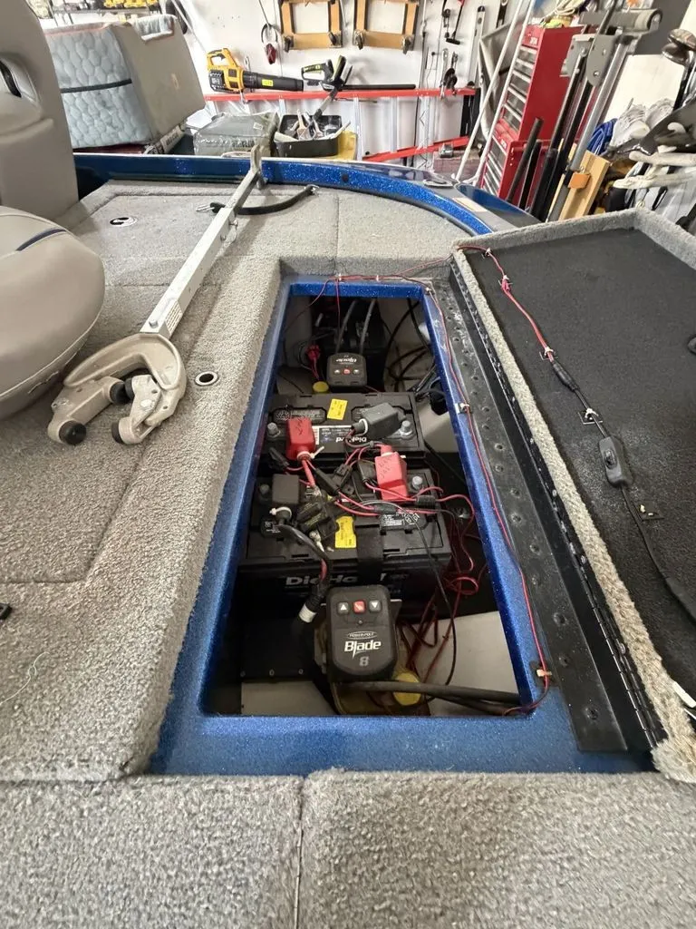 Slide: The Image of An open storage compartment on a 2018 Nitro Z18 boat reveals batteries and wiring. - 15