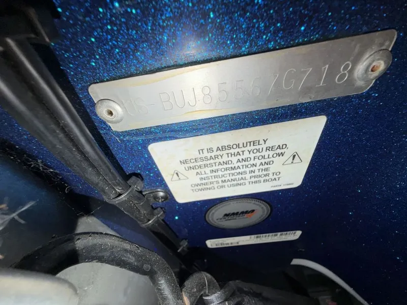 Slide: The Image of Close-up of a boat with a serial number and a warning label. - 31