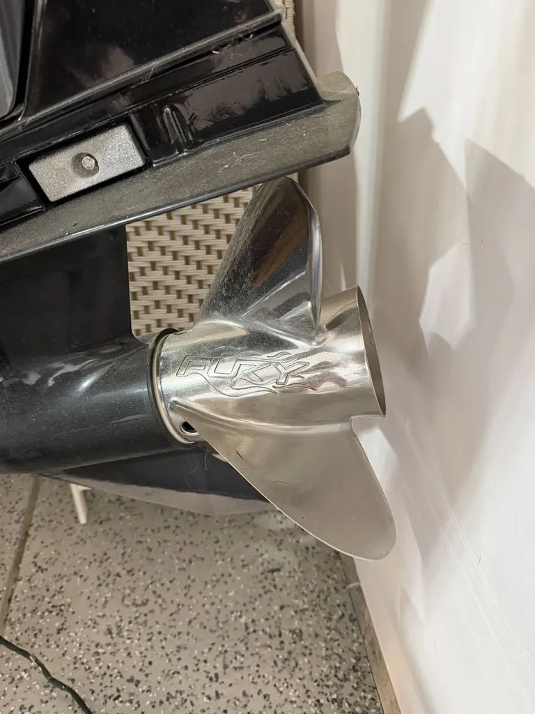 Slide: The Image of Close-up of a shiny propeller on a boat, set against a textured floor. - 28