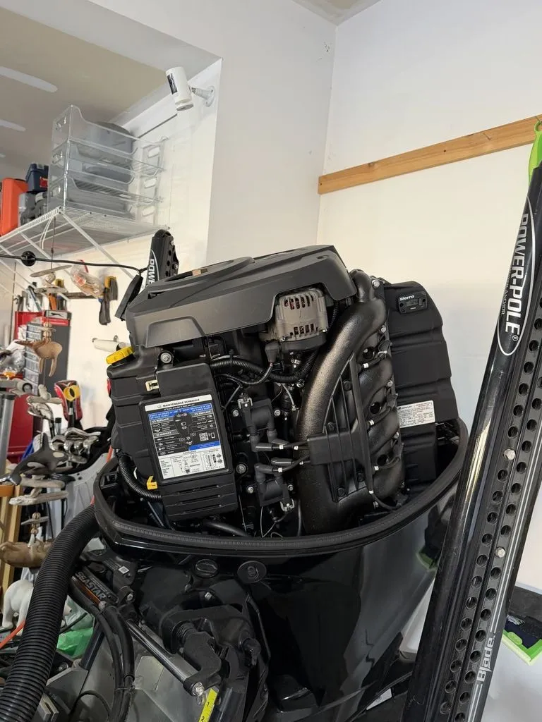 Slide: The Image of An outboard motor in a garage, surrounded by tools and equipment. - 26