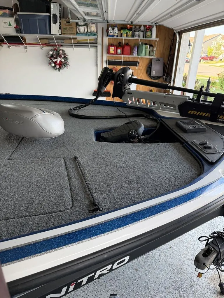 Slide: The Image of A 2018 Nitro Z18 boat in a garage. It features gray carpeting and a Minn Kota trolling motor. - 3