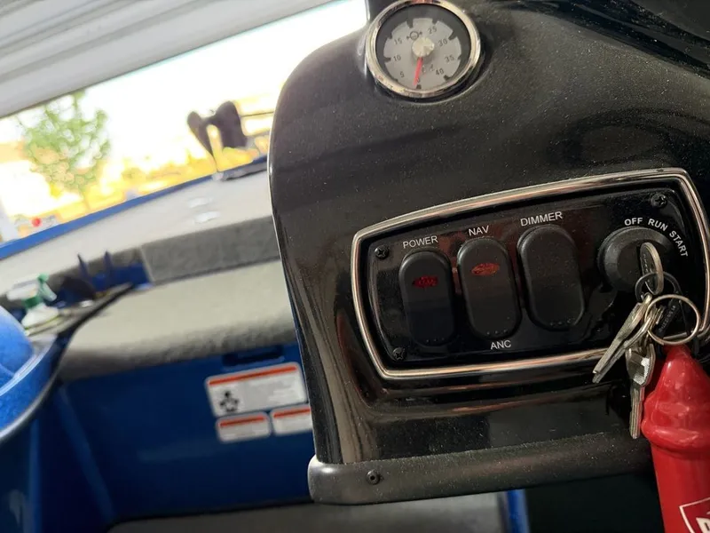 Slide: The Image of Close-up of a Nitro Z18 boat dashboard with switches and an ignition key. - 7