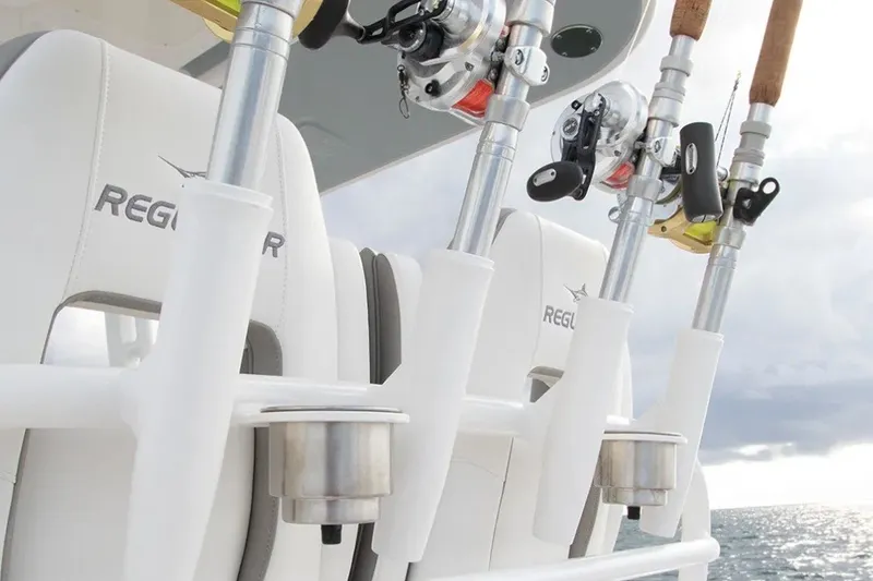 Slide: The Image of Fishing rods on a 2027 Regulator 28 Forward Seating boat, ocean backdrop. - 1