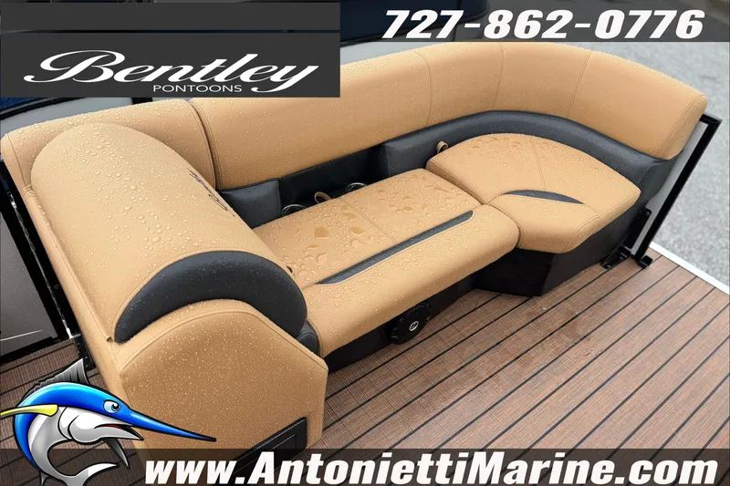 Slide: The Image of Bentley Pontoons Legacy 223 Swingback 2027 with tan seating, raindrops, and marine flooring. - 3