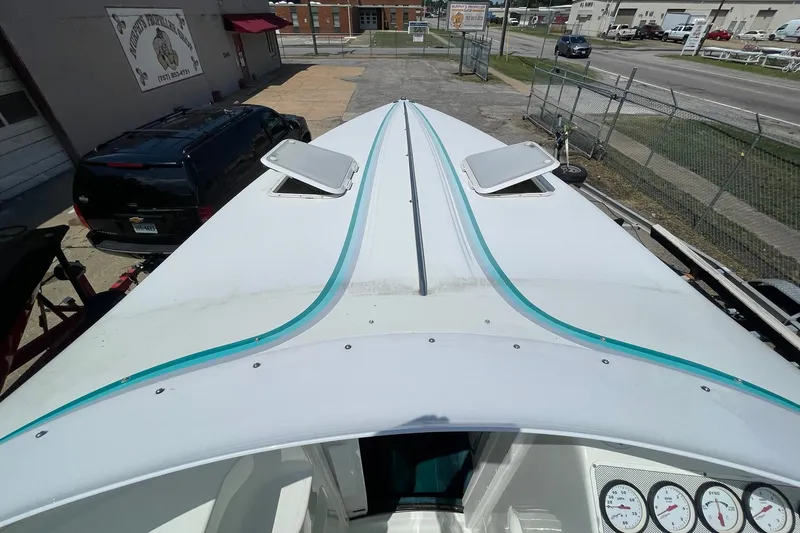 Slide: The Image of Top view of a 1996 Baja 322 boat with open hatches and visible gauges. - 4