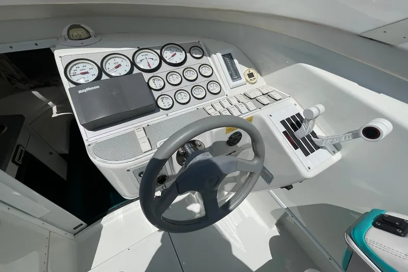 Slide: The Image of Cockpit of a 1996 Baja 322 boat with steering wheel and instrument panel. - 9