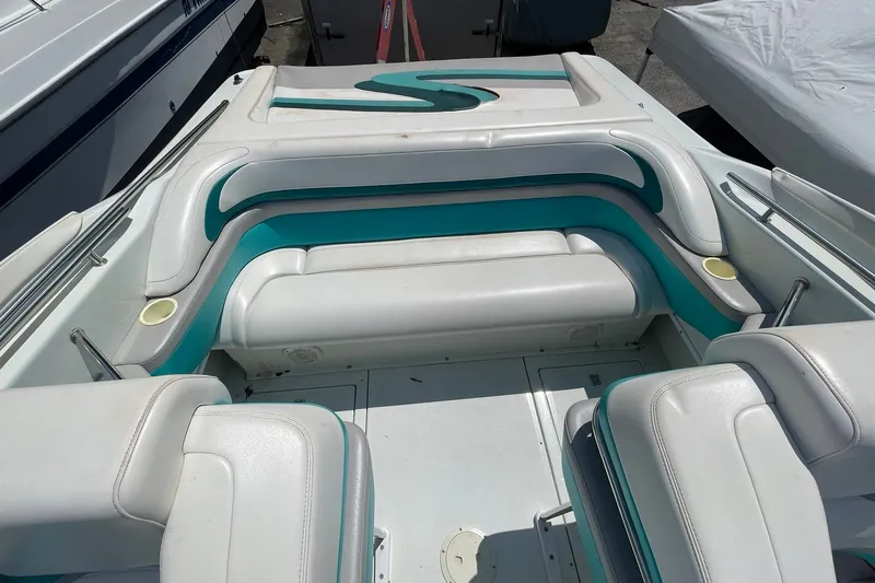 Slide: The Image of 1996 Baja 322 boat interior with white and teal seating arrangement. - 6