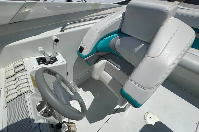 Slide: The Image of Interior of a 1996 Baja 322 boat featuring steering wheel and control panel. - 8