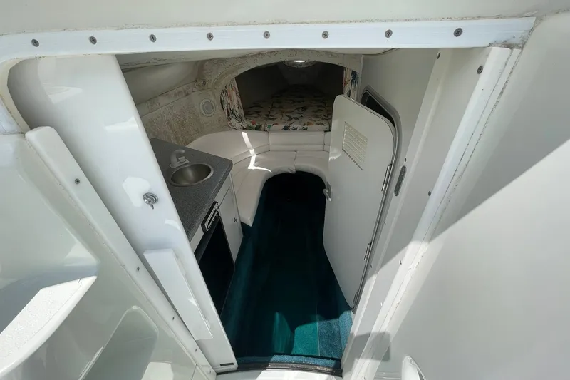 Slide: The Image of Interior of a 1996 Baja 322 boat with kitchenette and sleeping area. - 11