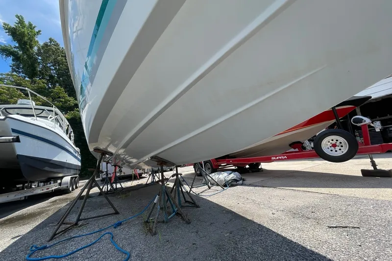 Slide: The Image of 1996 Baja 322 boat on stands, with trailer, in outdoor storage area. - 15