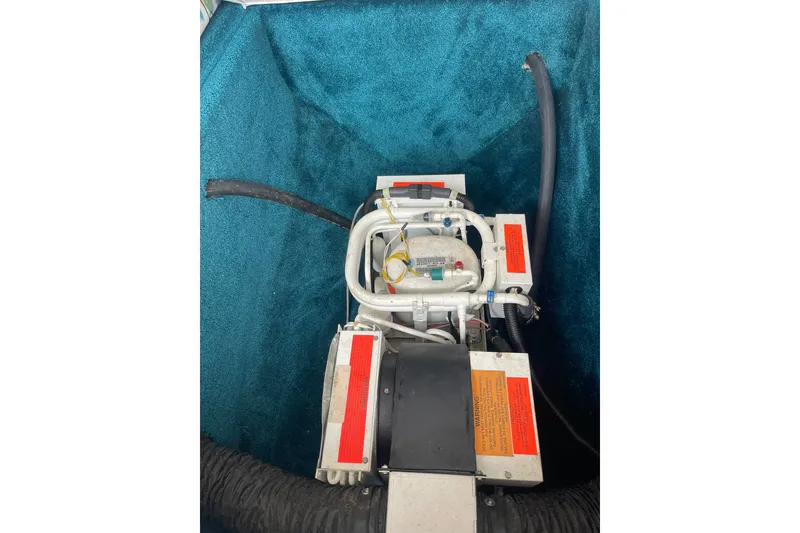 Slide: The Image of 1996 Baja 322 engine compartment with visible mechanical components and hoses. - 12