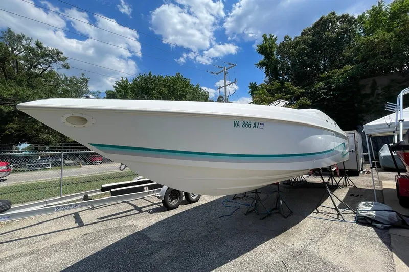 Slide: The Image of 1996 Baja 322 boat on trailer under clear blue sky. - 17