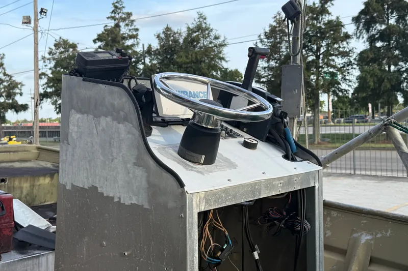 Slide: The Image of 1984 Alweld 1852PF boat console with steering wheel and exposed wiring. - 12
