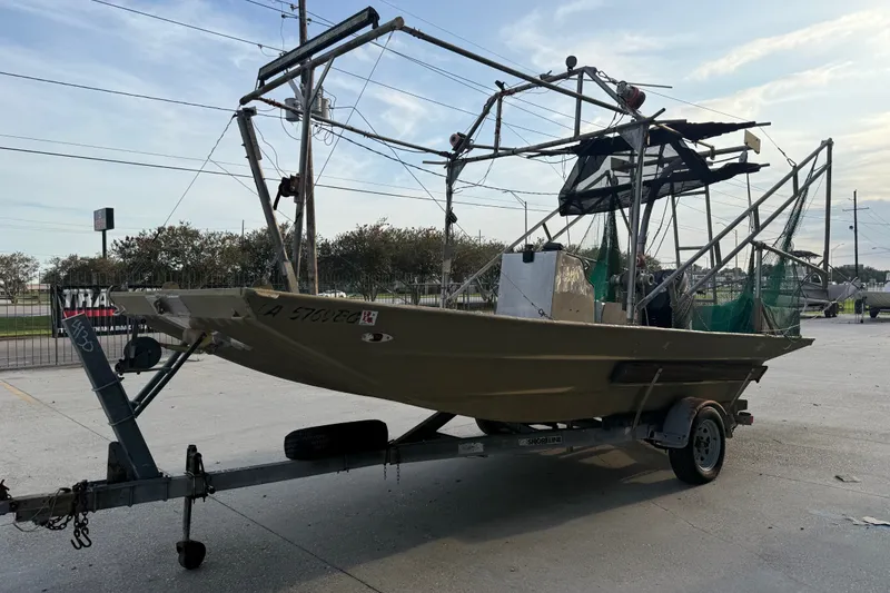 Slide: The Image of 1984 Alweld 1852PF boat on trailer, equipped with fishing nets and metal framework. - 7