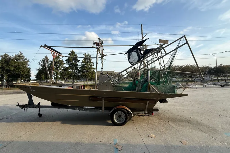 Slide: The Image of 1984 Alweld 1852PF boat on trailer, equipped with fishing nets and rigging. - 6