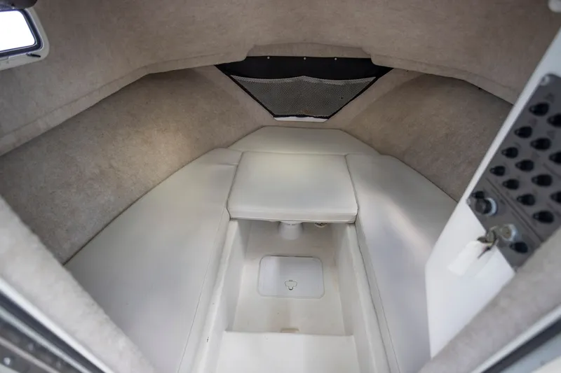 Slide: The Image of Interior cabin of 2022 Parker 2600 Center Console boat, featuring cushioned seating and storage. - 12