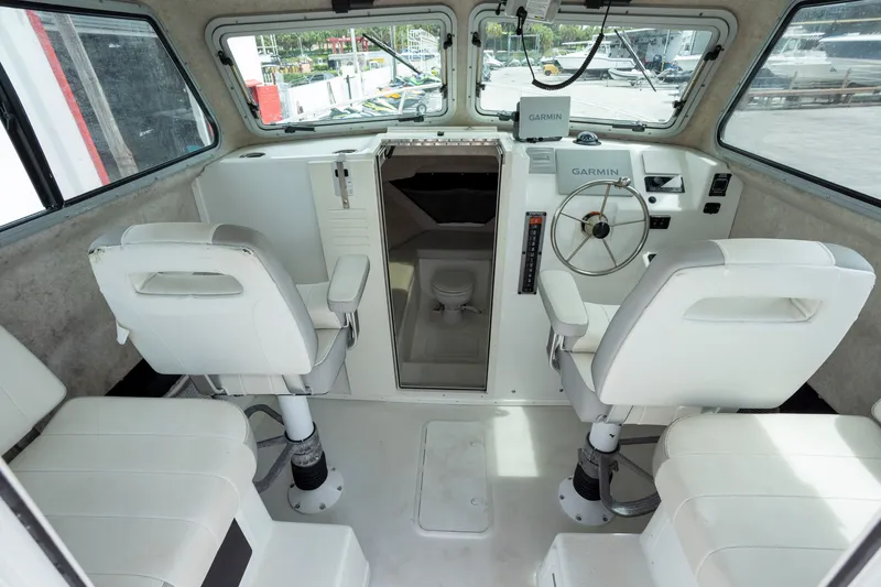 Slide: The Image of Interior of a 2022 Parker 2600 Center Console boat with white seating and Garmin equipment. - 3