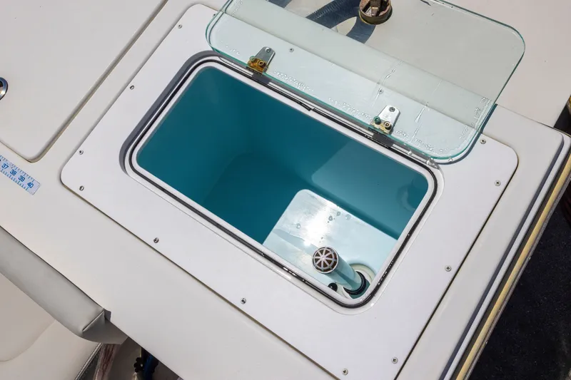 Slide: The Image of Livewell compartment on a 2022 Parker 2600 Center Console boat, open with clear lid. - 17